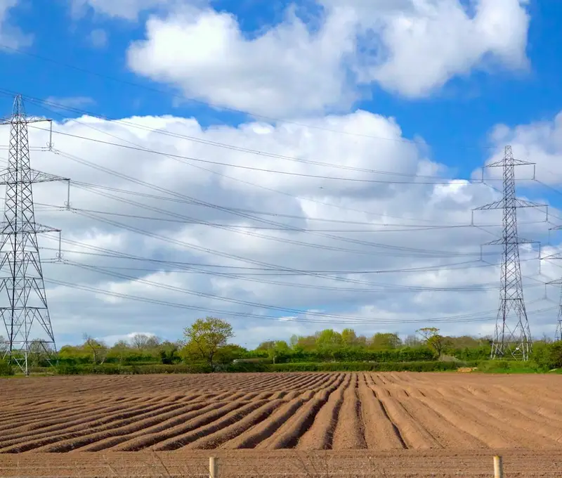 Electric transmission towers across farmland